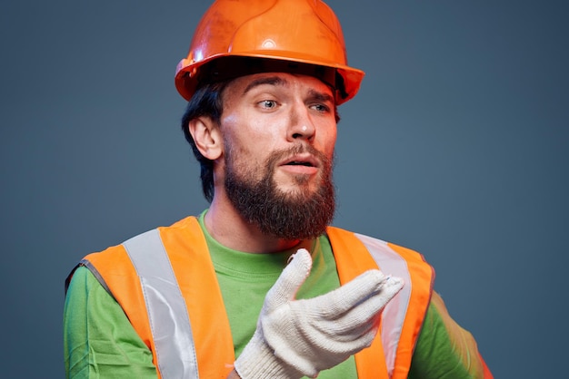 Man in work uniform orange paint safety work fatigue blue background