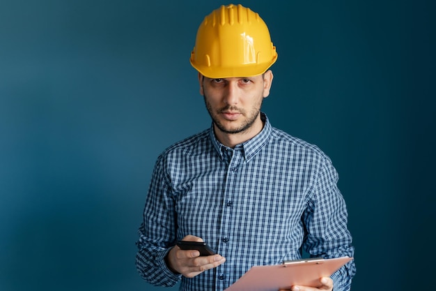 Man working against blue background