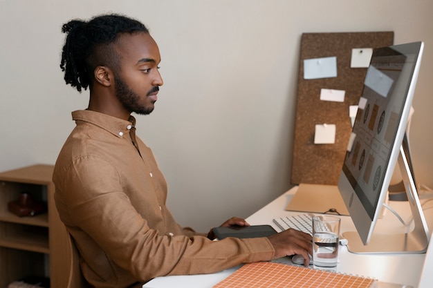 Man working on computer side view