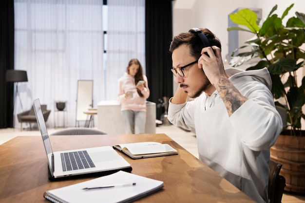 Man working from home at desk with laptop