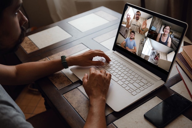 Man Working From Home Having Online Group Videoconference On Laptop