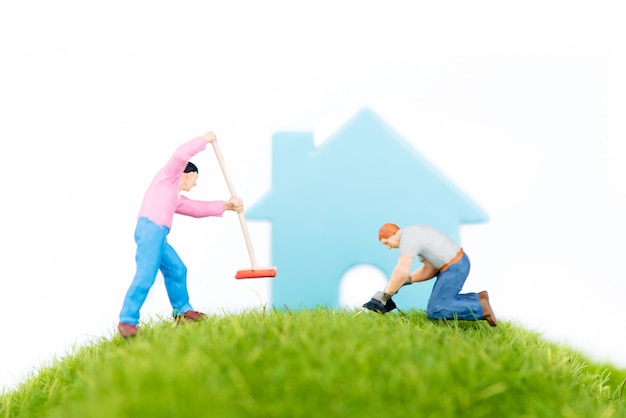 Man working on green grass on house