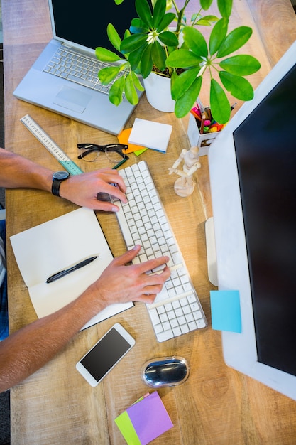 Man working at his desk and typing on keyboard in the office