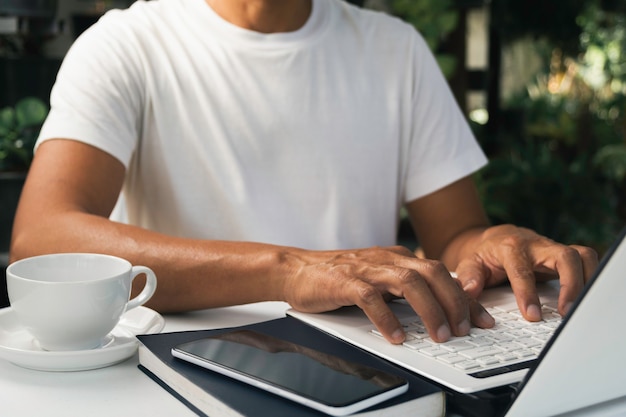 A man working at home and using laptop on the table. Technology and business concept.