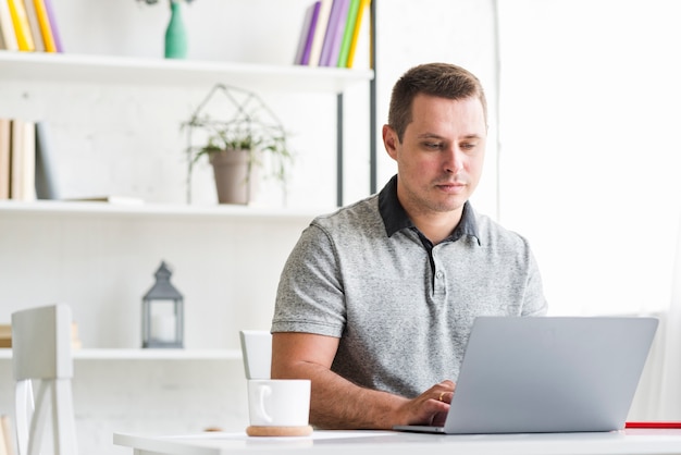 Man working on laptop at home