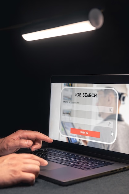 Man working on laptop and information for the searching job employment concept