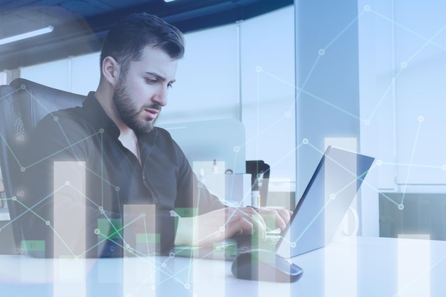 Man working at a laptop with different graphs around representing success in business and career