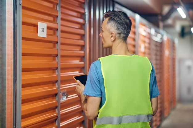 Man working in warehouse guard standing with back