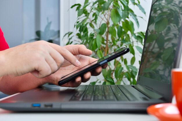 Man working with laptop and smart phone