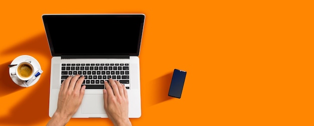 Man working with laptop, top view.