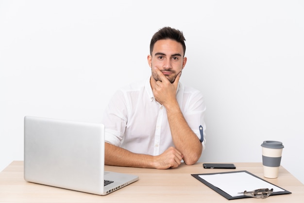 man in a workplace with a laptop