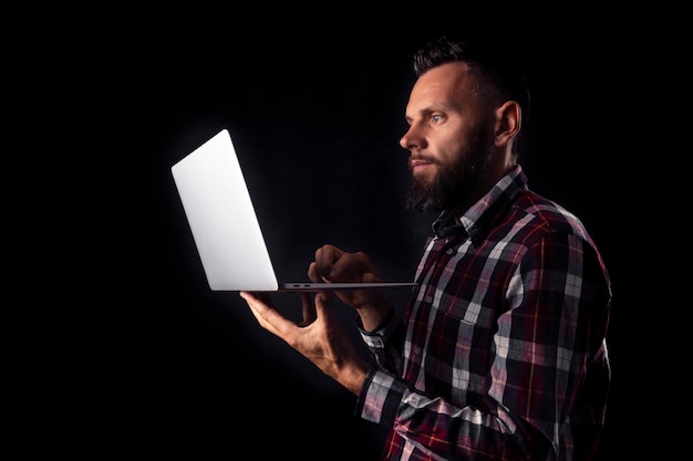 A man works in home on the black backgrounds