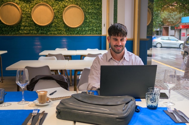 Man works remotely from a restaurant