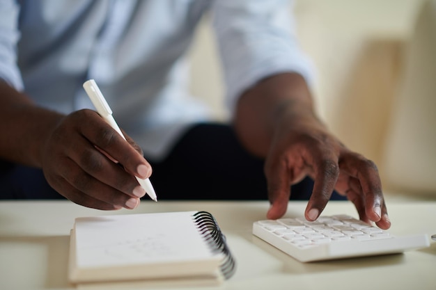 Man Writing down Incomes and Expenses