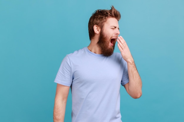 Man yawning and dreaming of sleep feeling drowsy inefficient to do job laziness and lack of energy