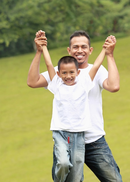 Man and young boy playing