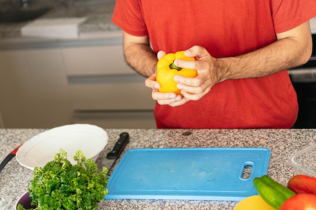 A man39s hands preparing a delicious salad at home