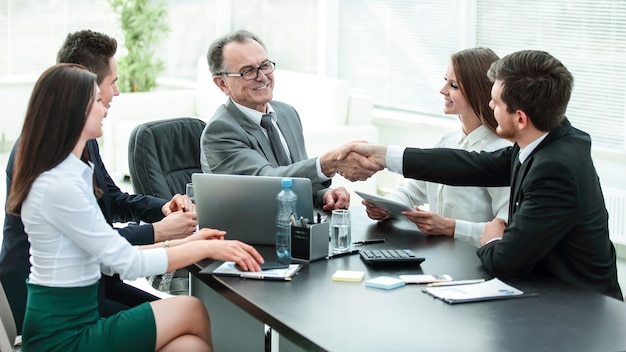 Manager and client shaking hands after discussing the contract.photo with place for text