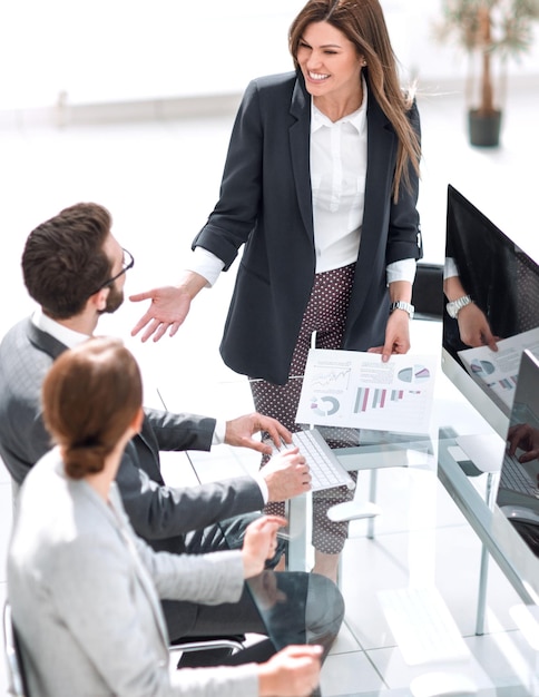 Manager discusses the financial report with the business team