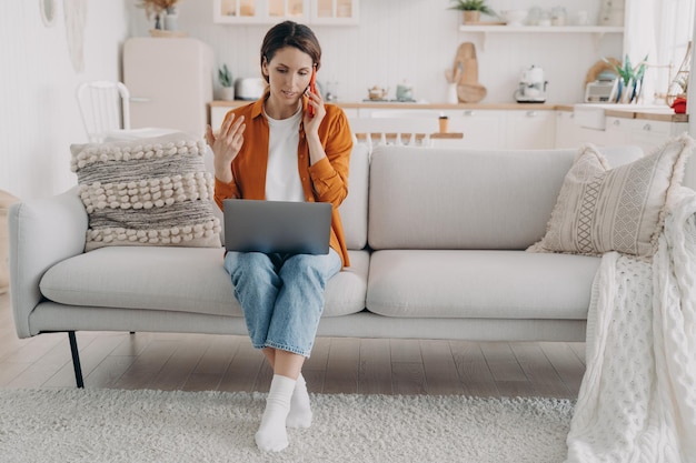 Manager explains to customer on phone Young european woman works at home on quarantine