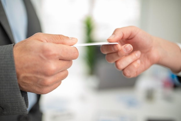 Manager giving his business card to a customer