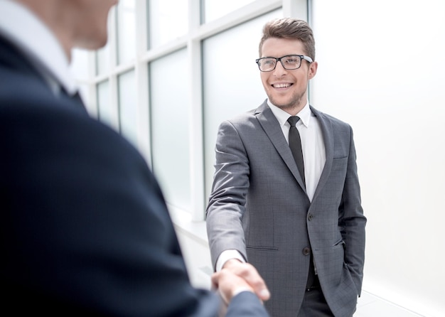 Manager greets the client with a handshakeconcept of partnership