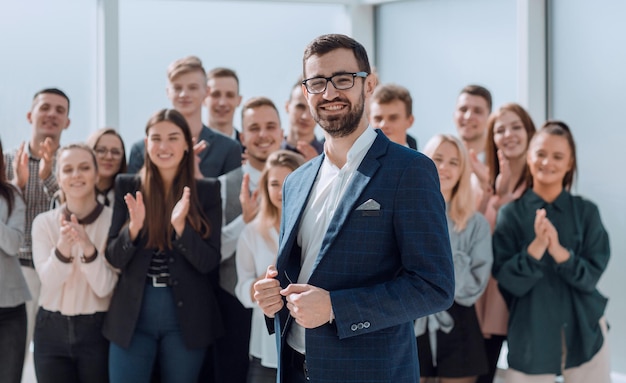 Manager and a group of diverse employees standing in the new office