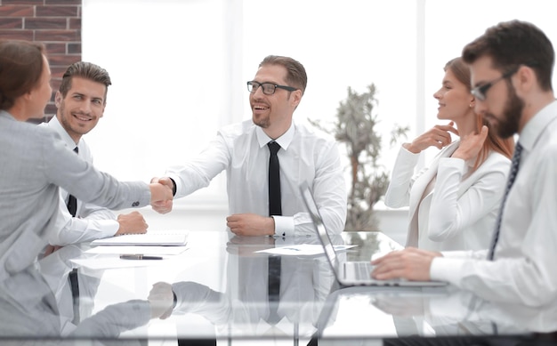 Manager shaking hands with a young business womanthe concept of cooperation