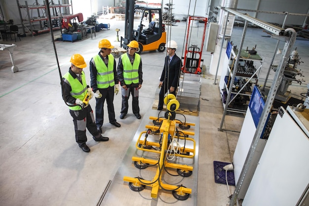 Manager and workers at factory