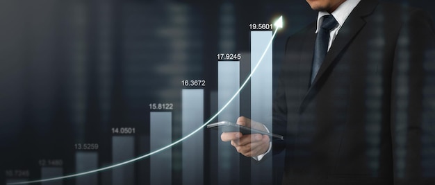 Mand holding smartphone device and touching screen Stock exchange market concept