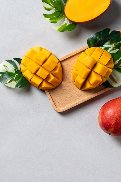 Mango background design concept Top view Diced fresh mango fruit on gray table