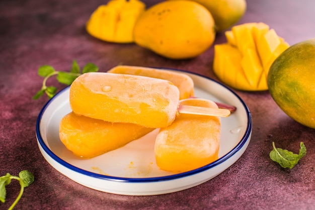 Mango banana popsicles with fresh fruits flat lay top view