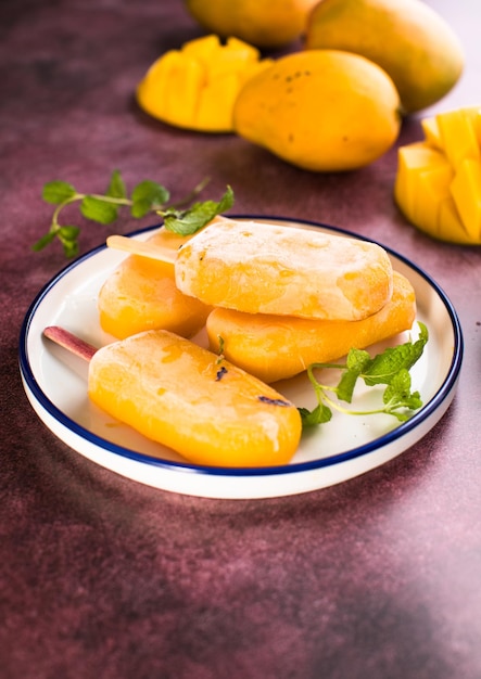 Mango banana popsicles with fresh fruits flat lay top view