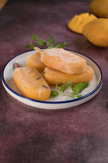 Mango banana popsicles with fresh fruits flat lay top view