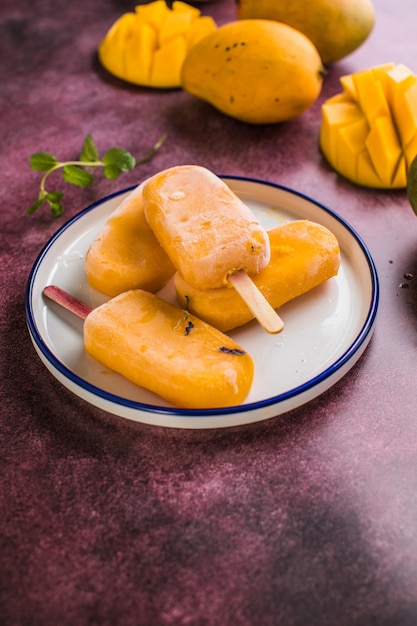 Mango banana popsicles with fresh fruits flat lay top view