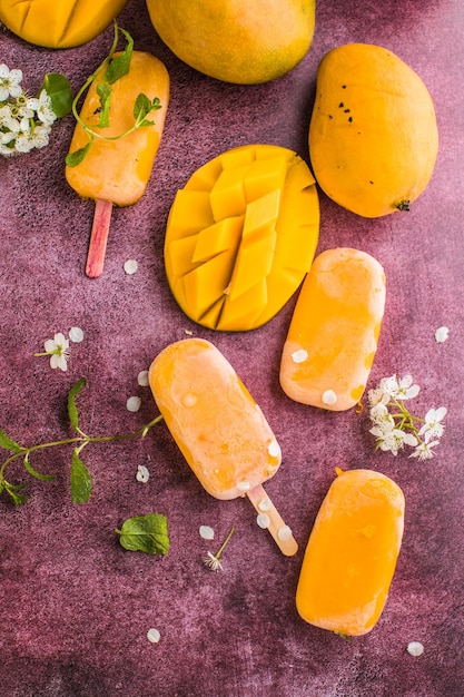 Mango banana popsicles with fresh fruits flat lay top view