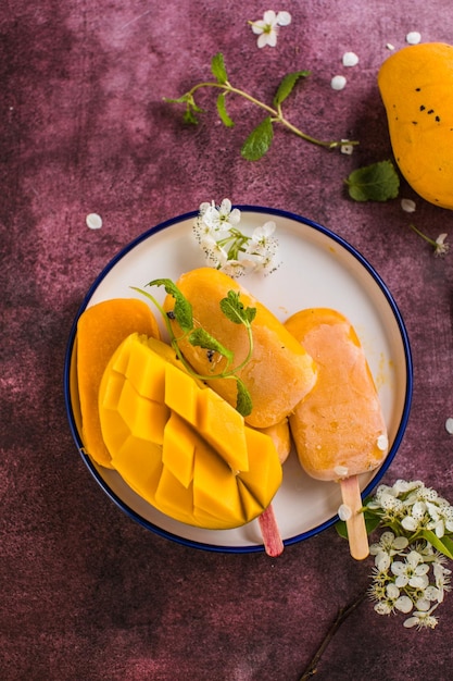 Mango banana popsicles with fresh fruits flat lay top view