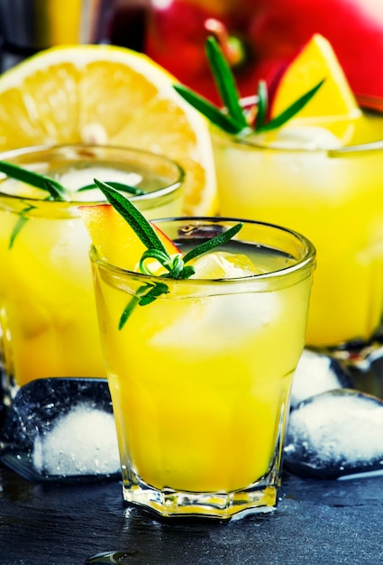 Mango lemonade with rosemary lemon juice and ice black background selective focus