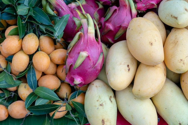 Mango pitahaya and marian plum for sale on street market in Thailand Tropical fruits close up