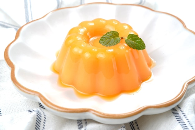 Mango pudding, jelly, dessert on white plate.on white background