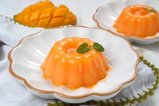 Mango pudding, jelly, dessert on white plate.on white background