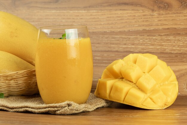 Mango smoothie juice. wooden background.