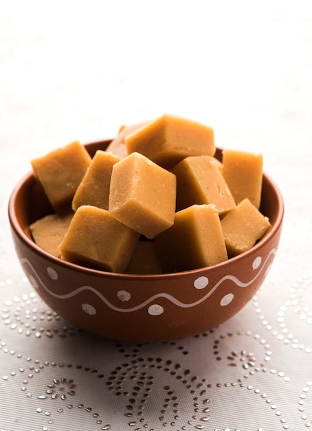 Mango Vadi and shrikhand Burfi served over moody background. selective focus