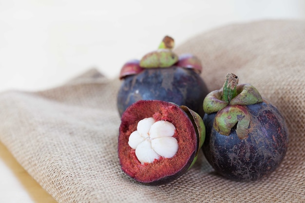 Mangosteen and cross section showing the thick purple skin