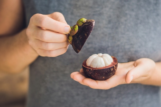 Mangosteen on farmer hand hold tropical fruit