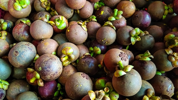 Photo mangosteen garcinia mangostana exotic fruit in fruit bowl