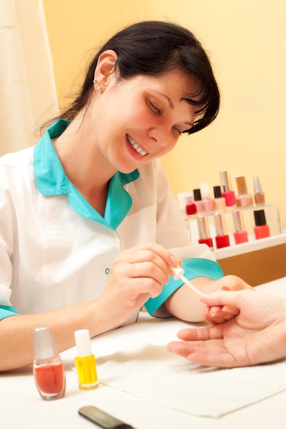 Manicure. Care of fingers of hands, cleaning, covering a varnish of nails.