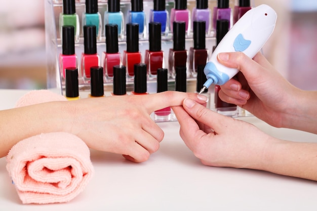 Manicure process in beauty salon close up