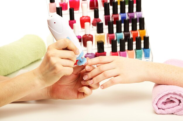 Manicure process in beauty salon close up