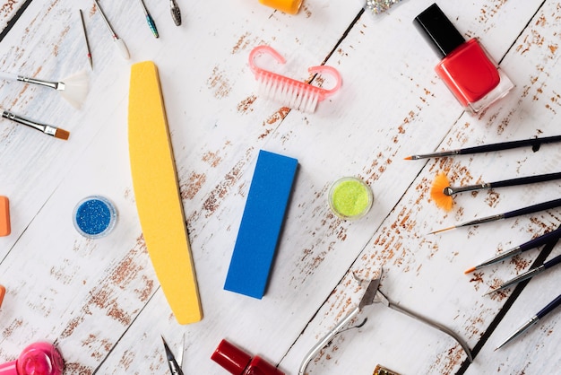 Manicure tools, sequins, nail polishes. the view from the top